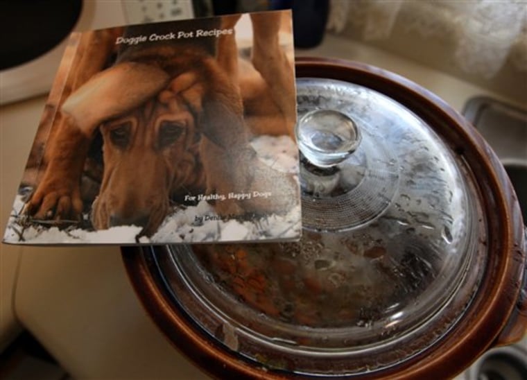 A cookbook of recipes for pets by Denise Rayzor of Palisade, Colo. is seen in this Jan. 20, 2012 photo. As people are getting choosier about what they eat, they’re insisting on providing their pets with more nutritious foods. (AP Photo/The Daily Sentinel, Dean Humphrey) MANDATORY CREDIT